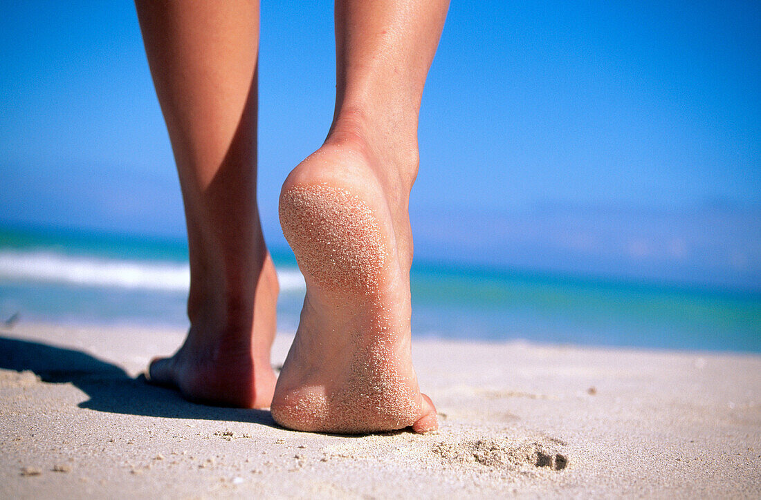 Woman s feet on beach. Caribbean