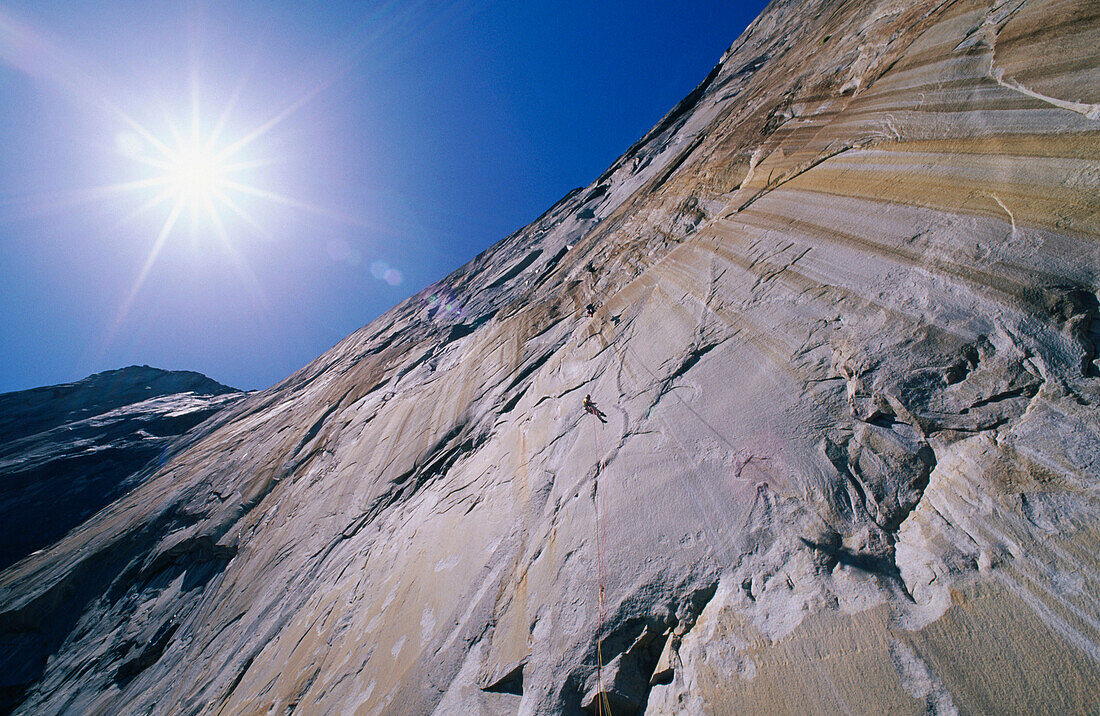 Sunflair over climber rapelling on El Capitan, Yosemite National Park. California. USA