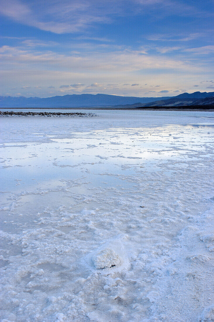 Flooded salt pan under the Funeral Mountains at dawn, Death Valley National Park, California