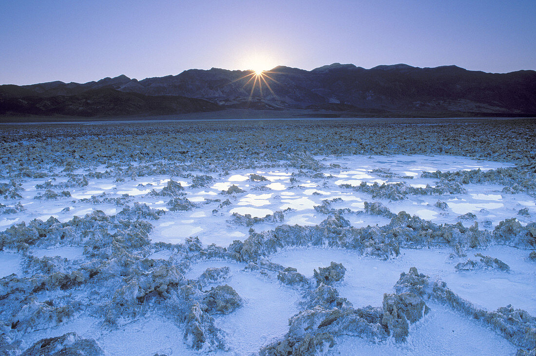 Salt pan and sunrise over the Amargosa Range, Death Valley National Park, California