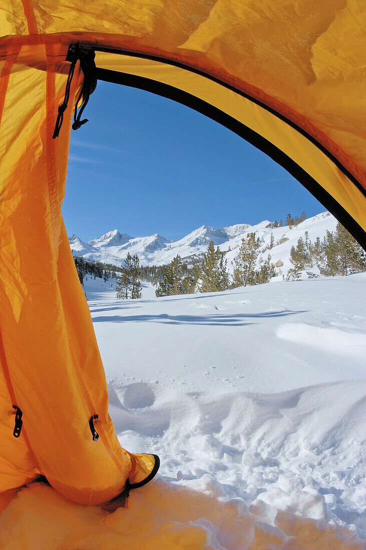 Blue sky over Sierra peaks through the door of a yellow dome tent, Little Lakes Valley, Inyo National Forest, Sierra Nevada Mountains, California
