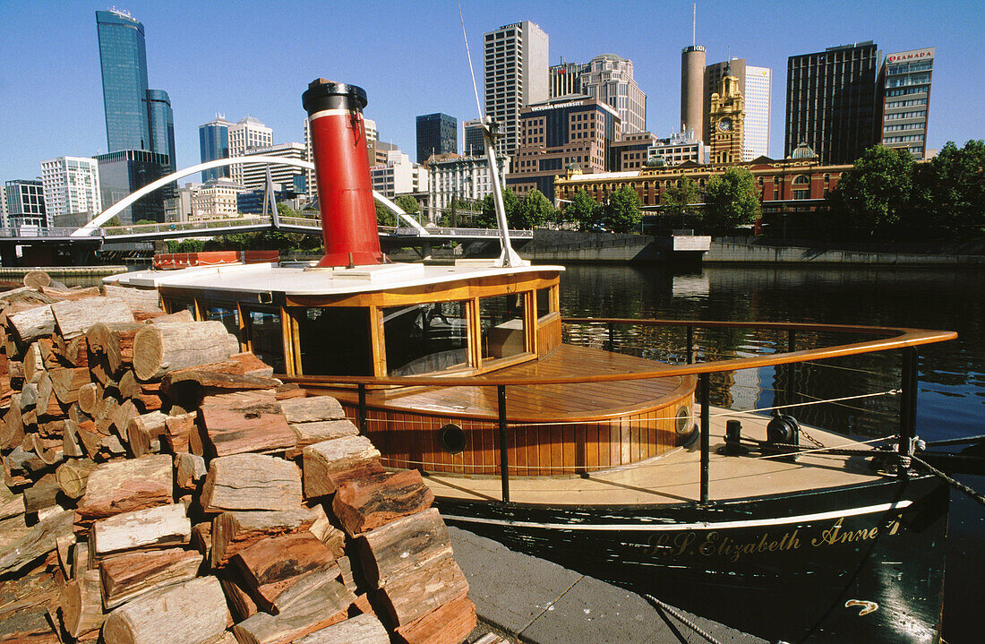 Tourist steamer on Yarra River with CBD at the background. Melbourne. Victoria, Australia