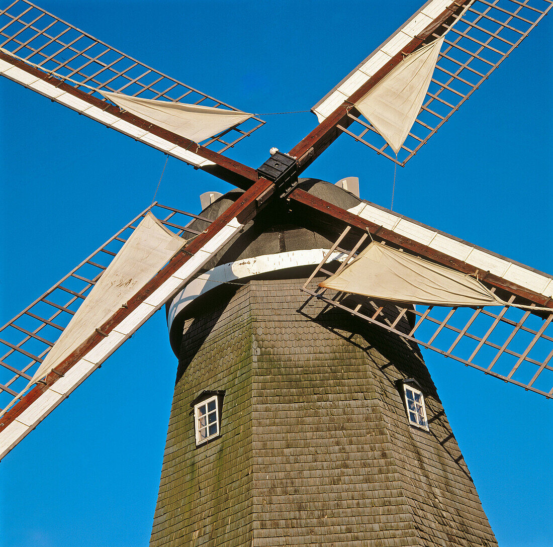 Old windmill with sail on the wings. Bjäre peninsula, Skåne, Sweden