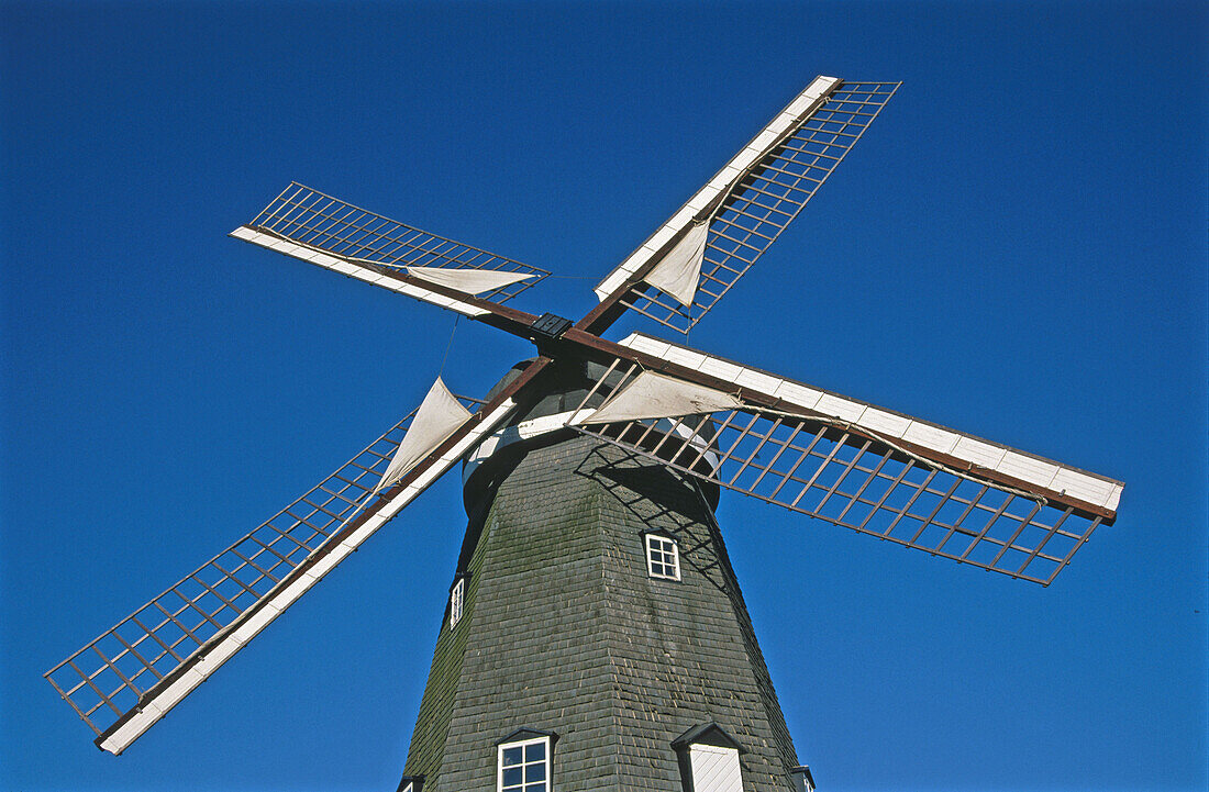 Old windmill with sail on the wings. Bjäre peninsula, Skåne, Sweden