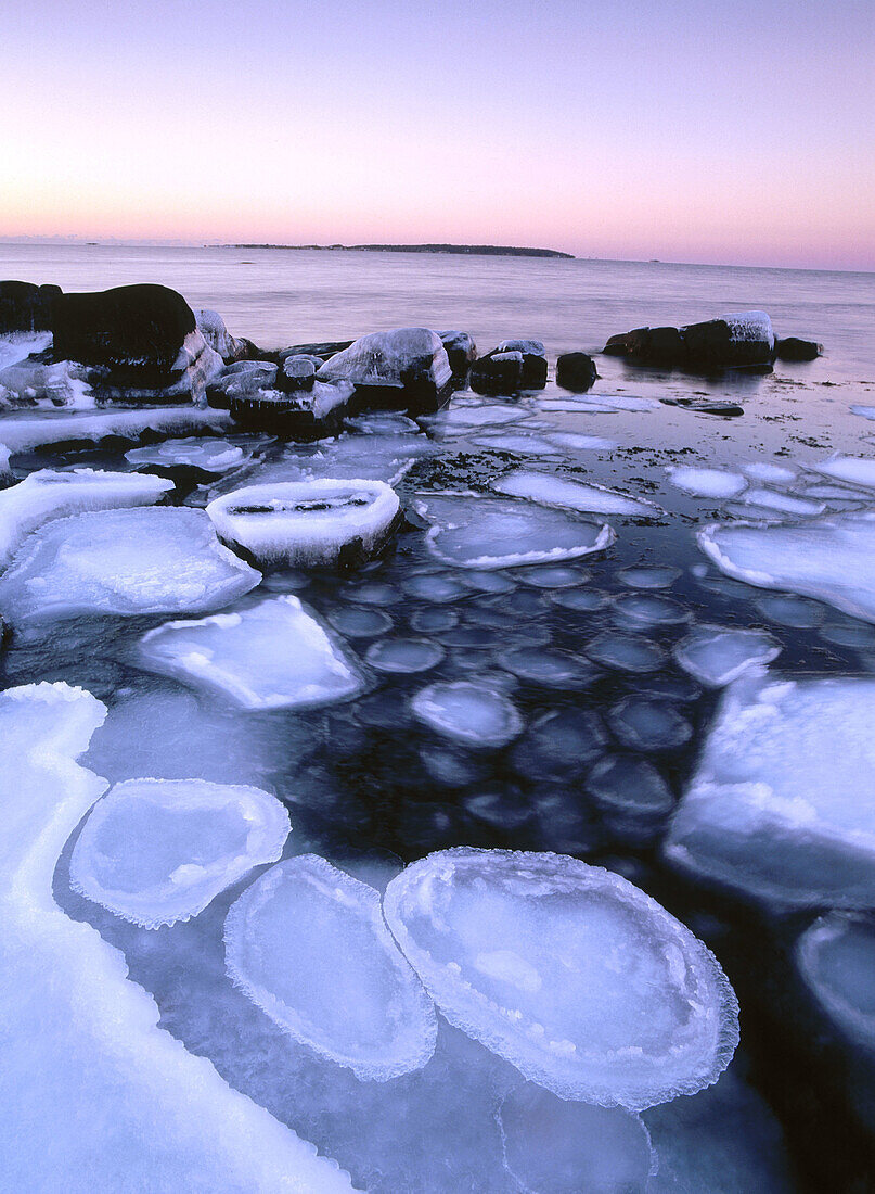 Ice and stones by the shoreline of Kattegatt Sea. Skåne. Sweden