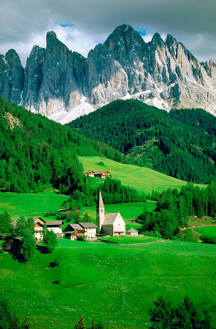 Village of Santa Magdalena in in the Odles Mountains (Val di Funes). Dolomites at the background. Alps. Italy