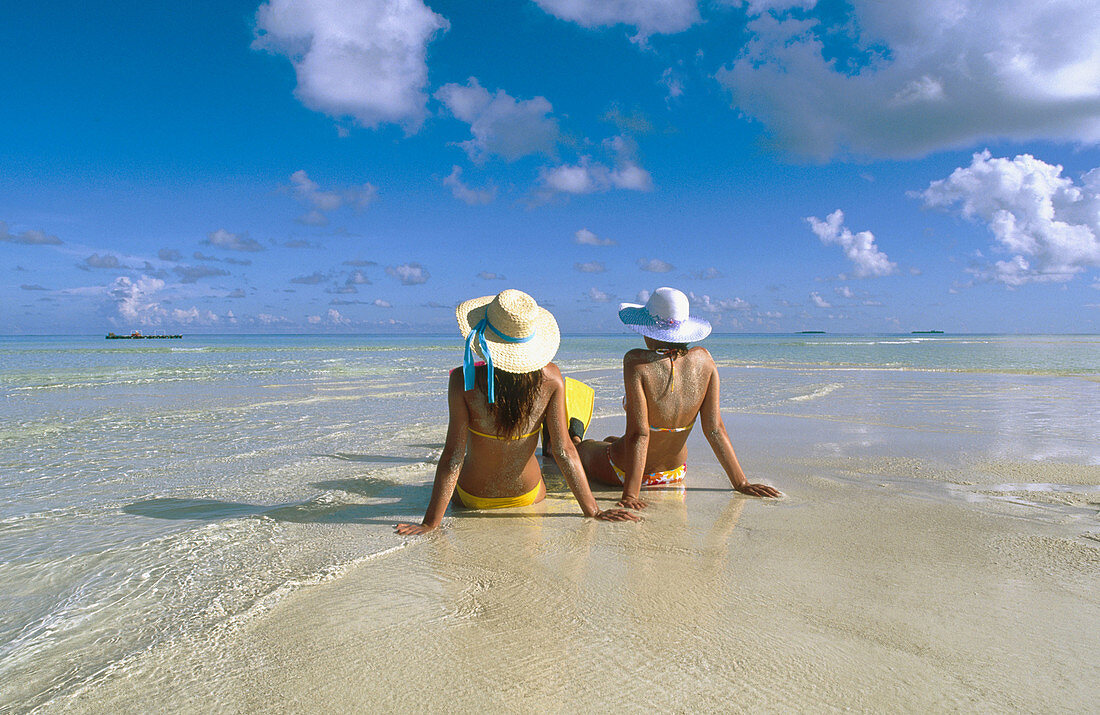 Women on the beach in White Sands Resort and Spa. Ari Atoll. Maldives