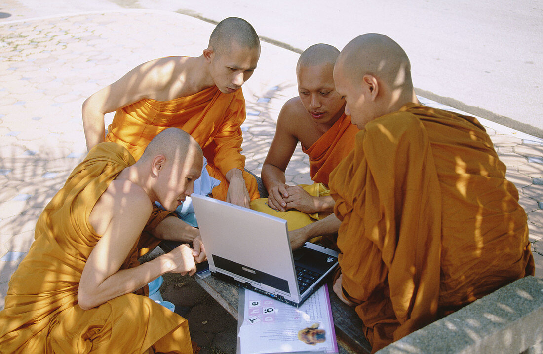 Monks with computer. Temple Wat Suan Dok. Chiang Mai. Thailand