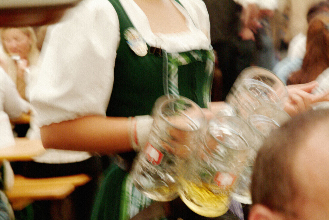 Waitress in beer tent during Oktoberfest. Munich, Germany