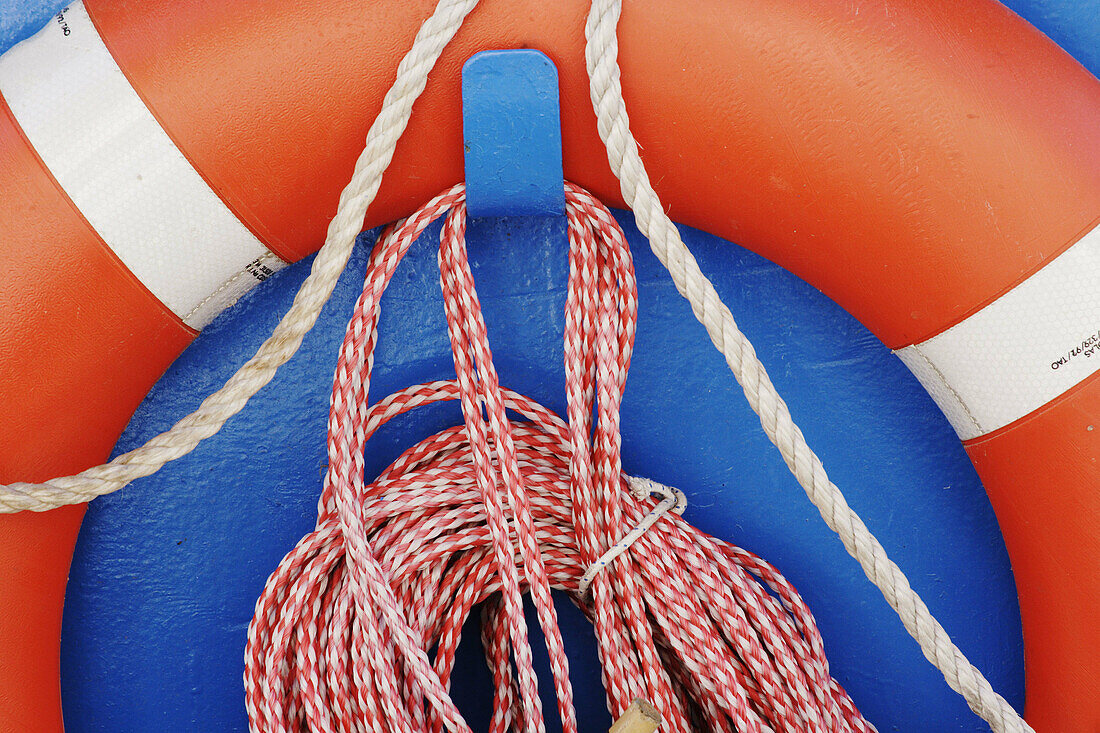 Life belt and ropes on a boat, Canale Grande, harbour, Adriatic Sea. Grado, Regione Autonoma Friuli Venezia Giulia, Italy. Europe.