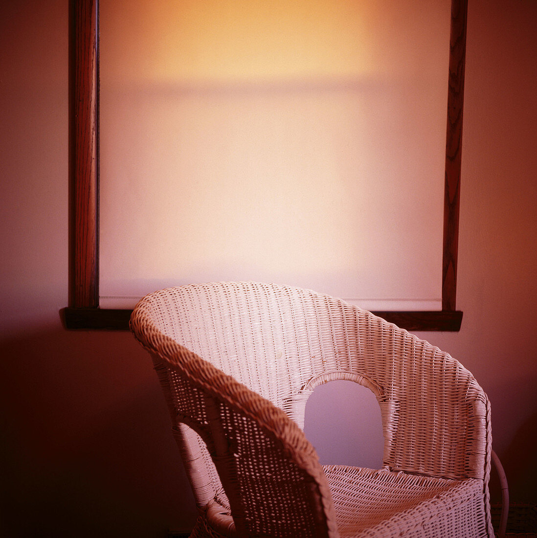 Wicker chair by window