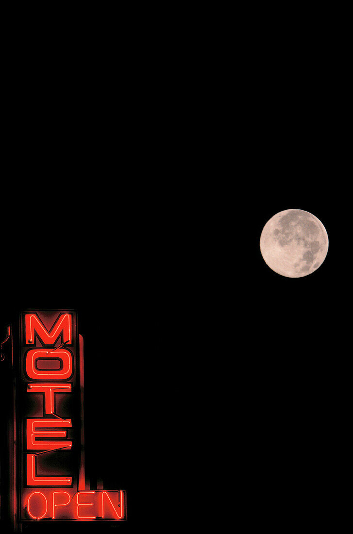 Neon Motel sign with full moon in background