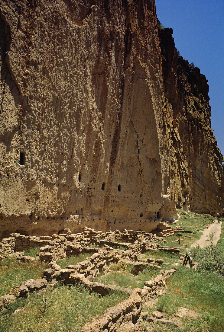 Long House and steep cliff with carved rooms at Bandelier National Monument. New Mexico, USA