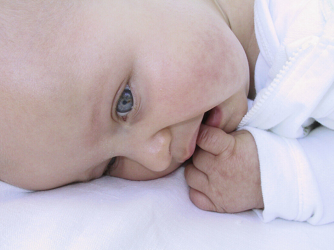 9 month old baby boy sucking his finger