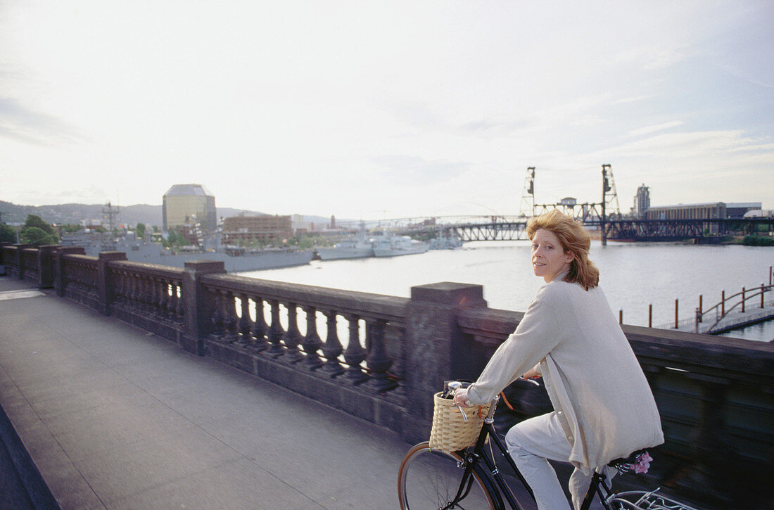 Woman touring across bridges at sunset. Portland. Oregon. USA