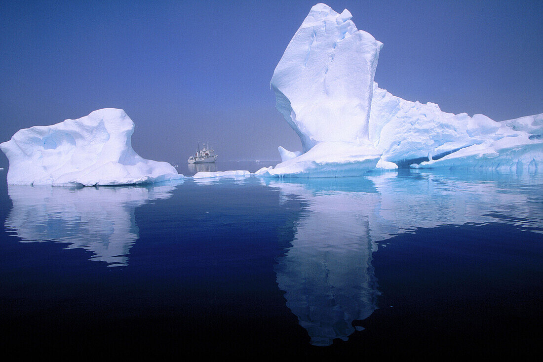 Progressor Kromov cruise vessel framed by iceberg. Petermann Island. Antarctica