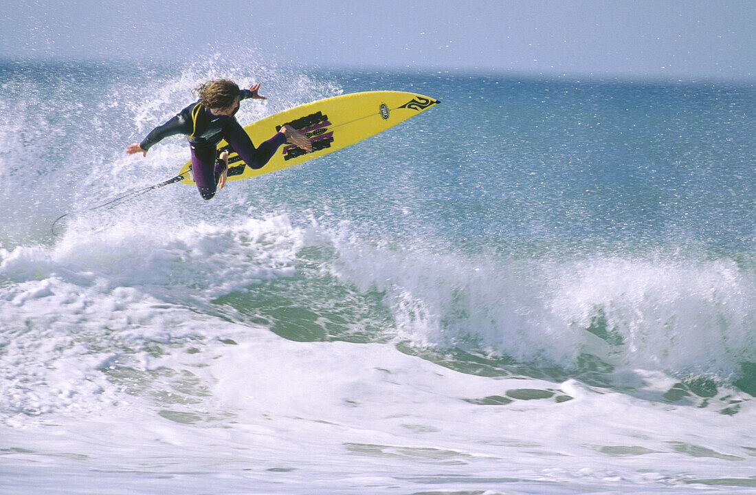 Surfer. Wainui beach. New Zealand.