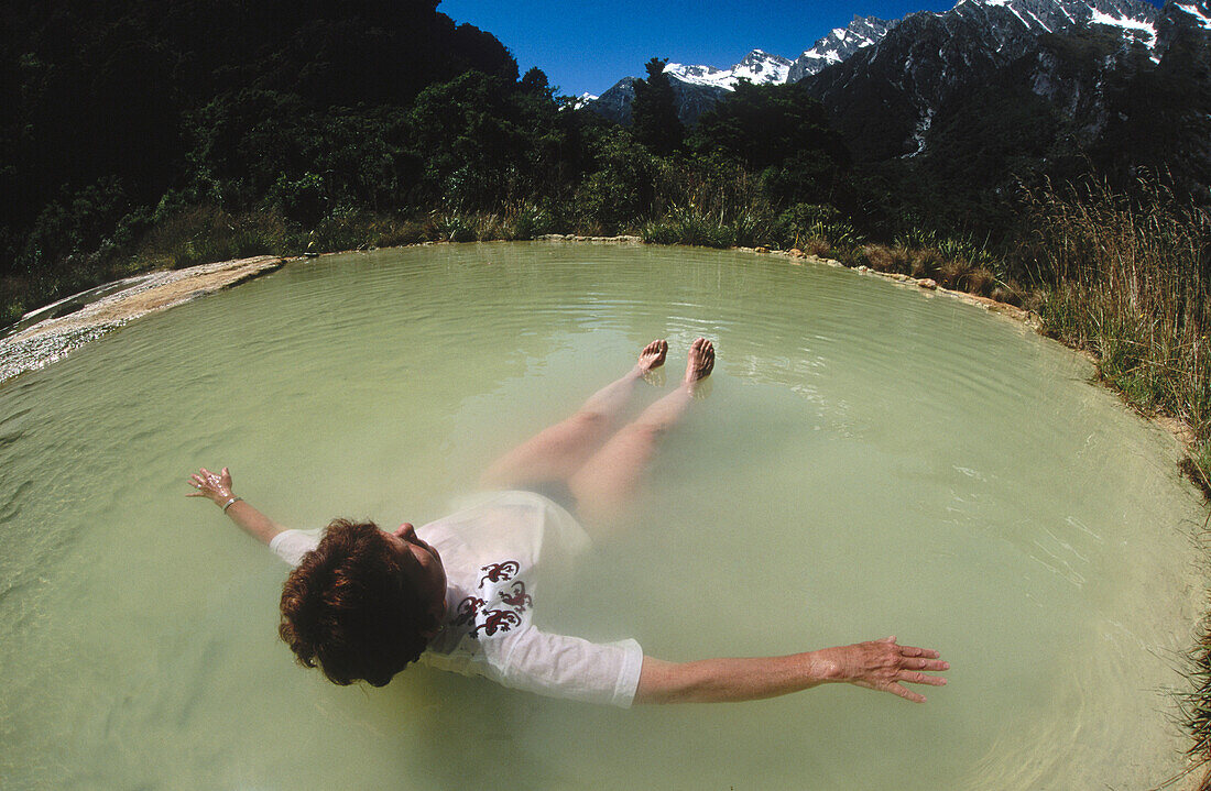 Relaxing in Welcome Flat hot pools. Natural thermal pools. Edge of Alpine Fault. Copland Valley. Westland National Park. South Island. New Zealand.