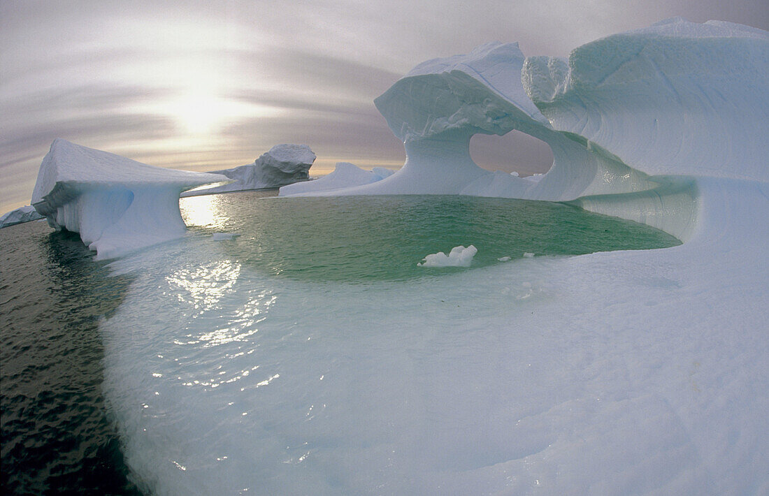 Sculpted Iceberg and storm clouds. Pleneau Island. Antartica