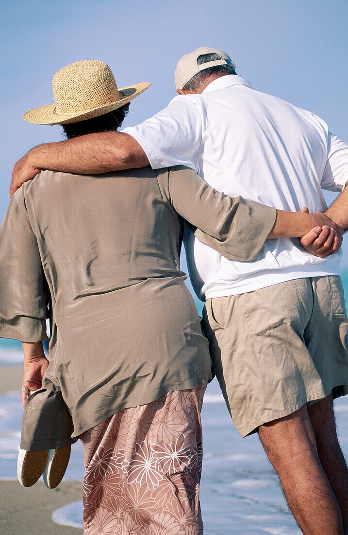 Mature couple walking at the beach