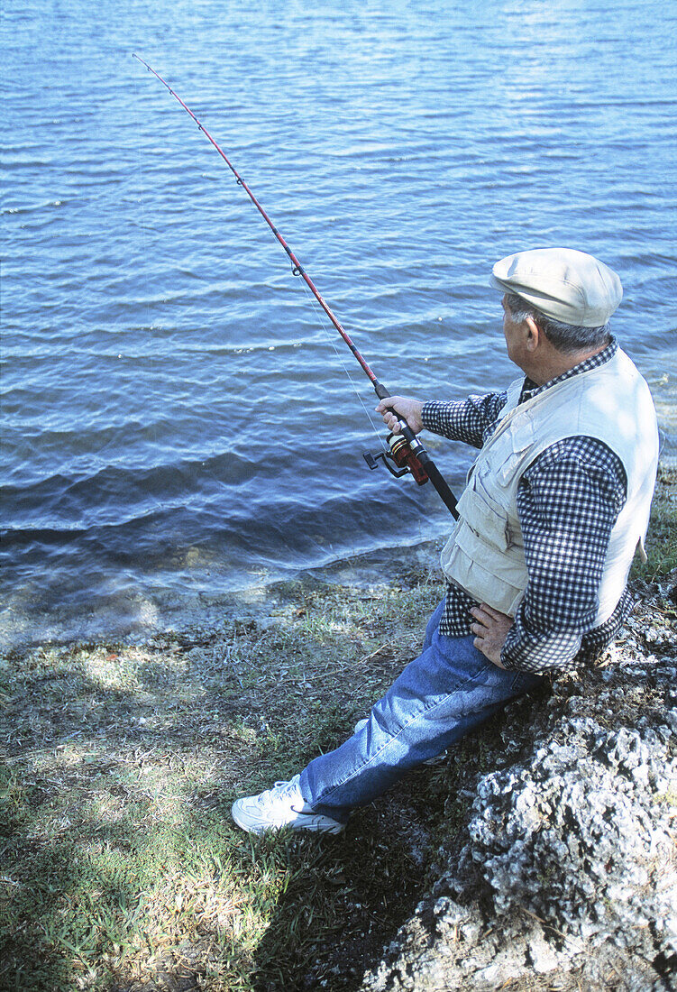 Mature man fishing in a lake, Florida, USA