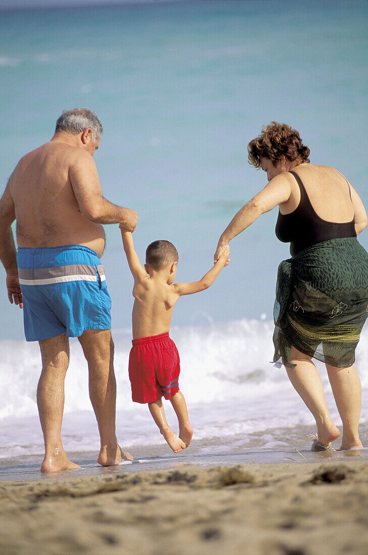  60 to 70 years, 60-65 years, 60-70 years, Amusement, Back view, Bathing suit, Bathing suits, Beach, Beaches, Boy, Boys, Caucasian, Caucasians, Child, Children, Coast, Coastal, Color, Colour, Contemp