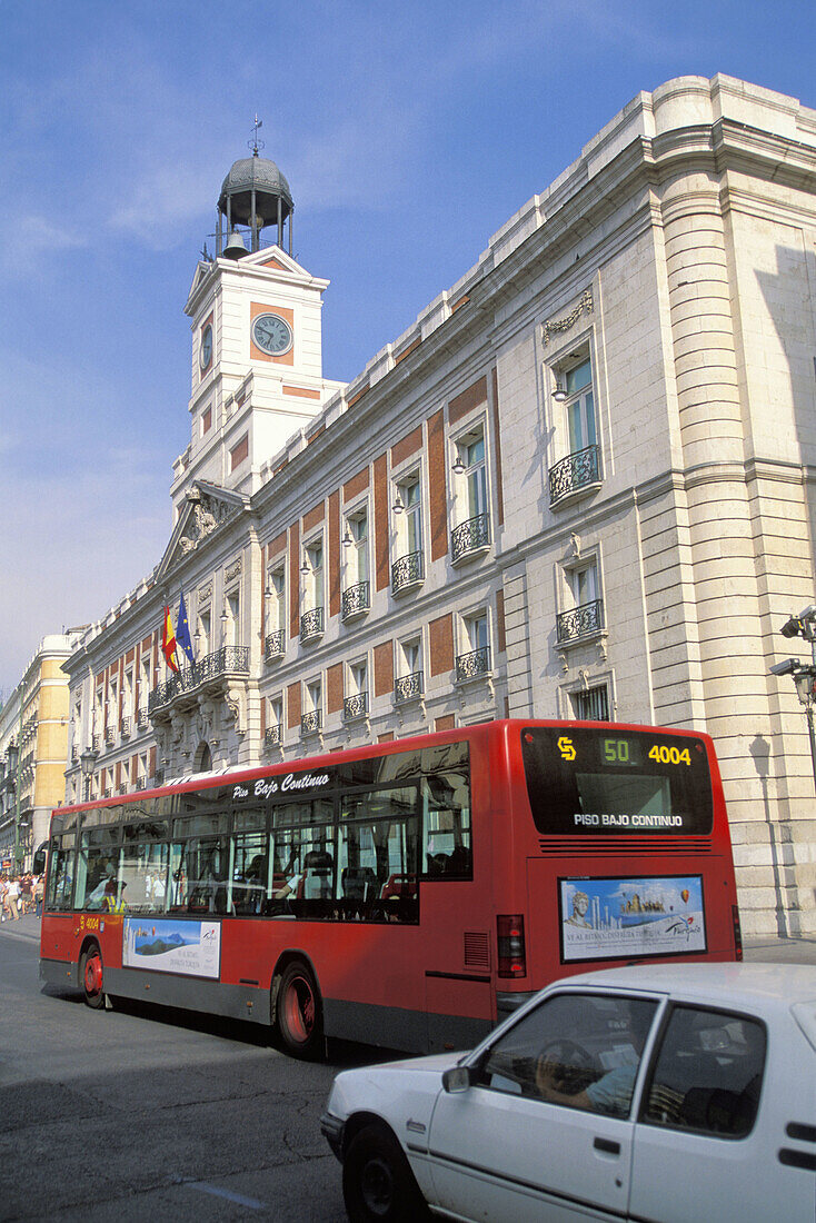 Casa de Correos (regional government building) and bus at Puerta del Sol. Madrid. Spain
