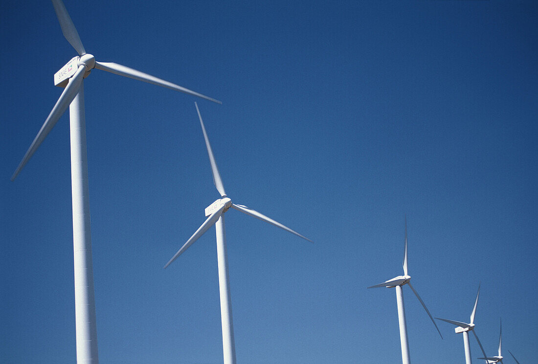  Blue, Blue sky, Color, Colour, Daytime, Energy, Environment, Exterior, Horizontal, Industrial, Industry, Motion, Movement, Moving, Outdoor, Outdoors, Outside, Power, Renewable energy, Skies, Sky, Wind, Wind farm, Wind farms, Wind power, Wind power plant,