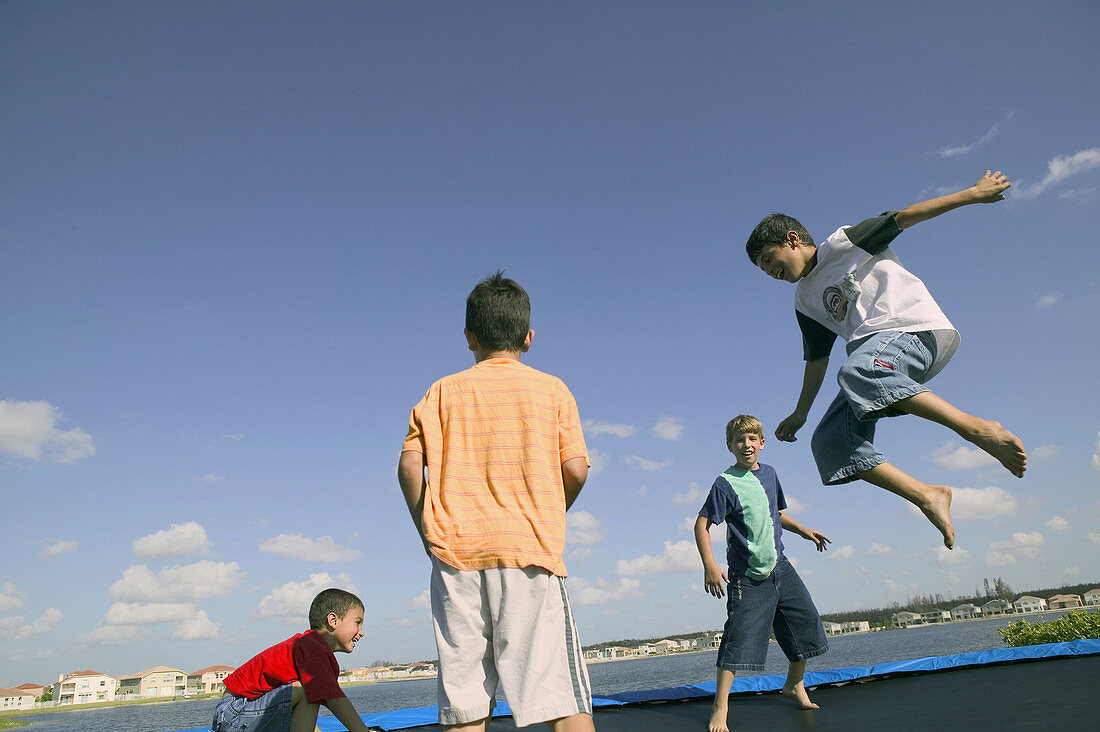 Boys jumping on trampoline outdoor