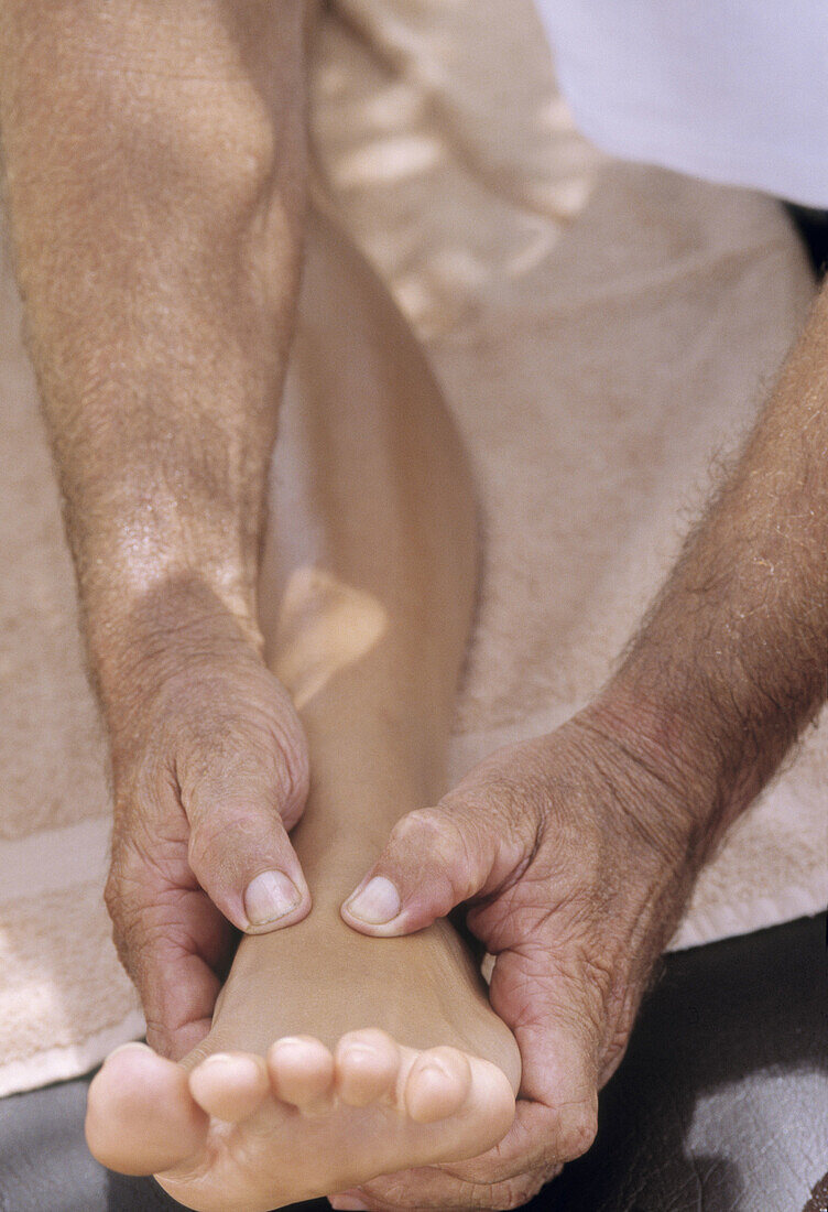 Woman getting a foot massage outdoor in a spa