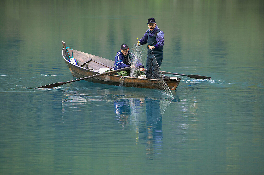 Two men fishing with net. Oldevatnet. Sogn og Fjordane, Norway, Scandinavia, Europe.