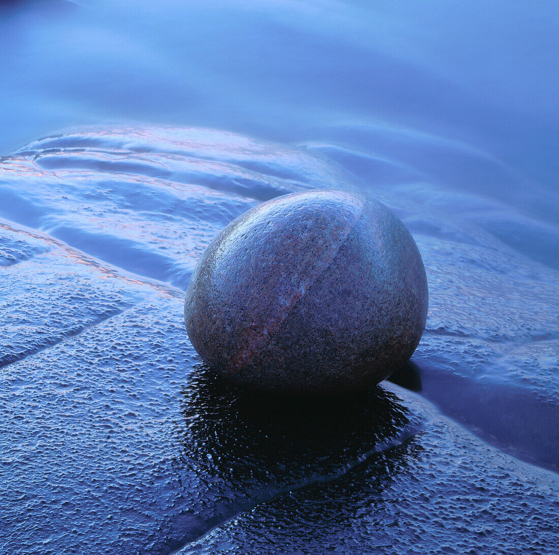 Stone on rock at waters edge. Hovs Hallar, Kattegatt Sea, Skåne, Sweden, Scandinavia, Europe.