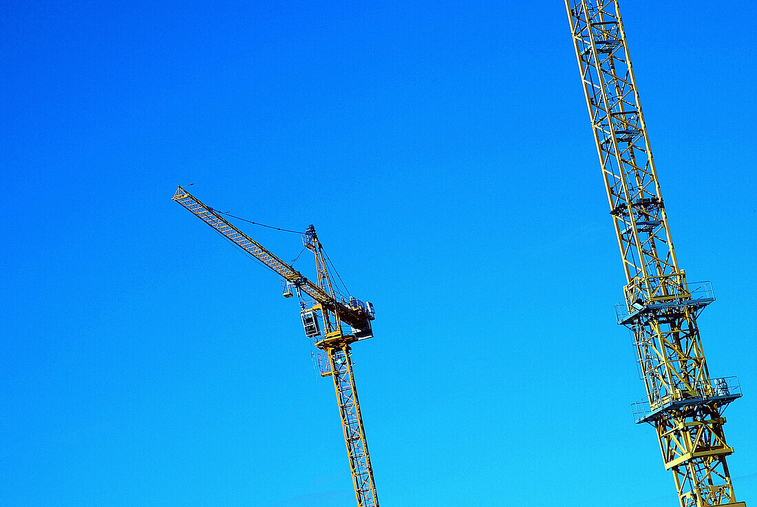  Blue, Blue sky, Color, Colour, Construction, Crane, Cranes, Daytime, Detail, Details, Economy, Engineering, Exterior, Height, Horizontal, Industrial, Industry, Outdoor, Outdoors, Outside, Pair, Skies, Sky, Tall, Two, G96-220075, agefotostock 