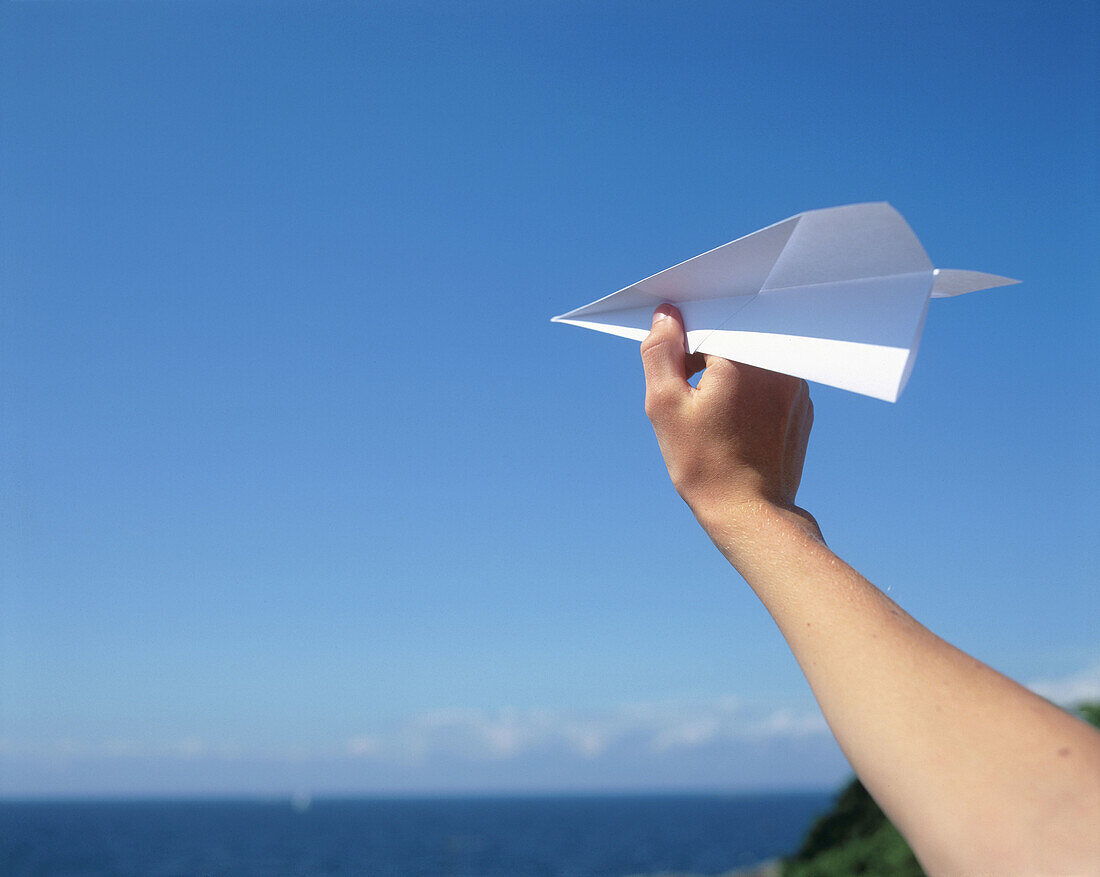 Hand with paper plane