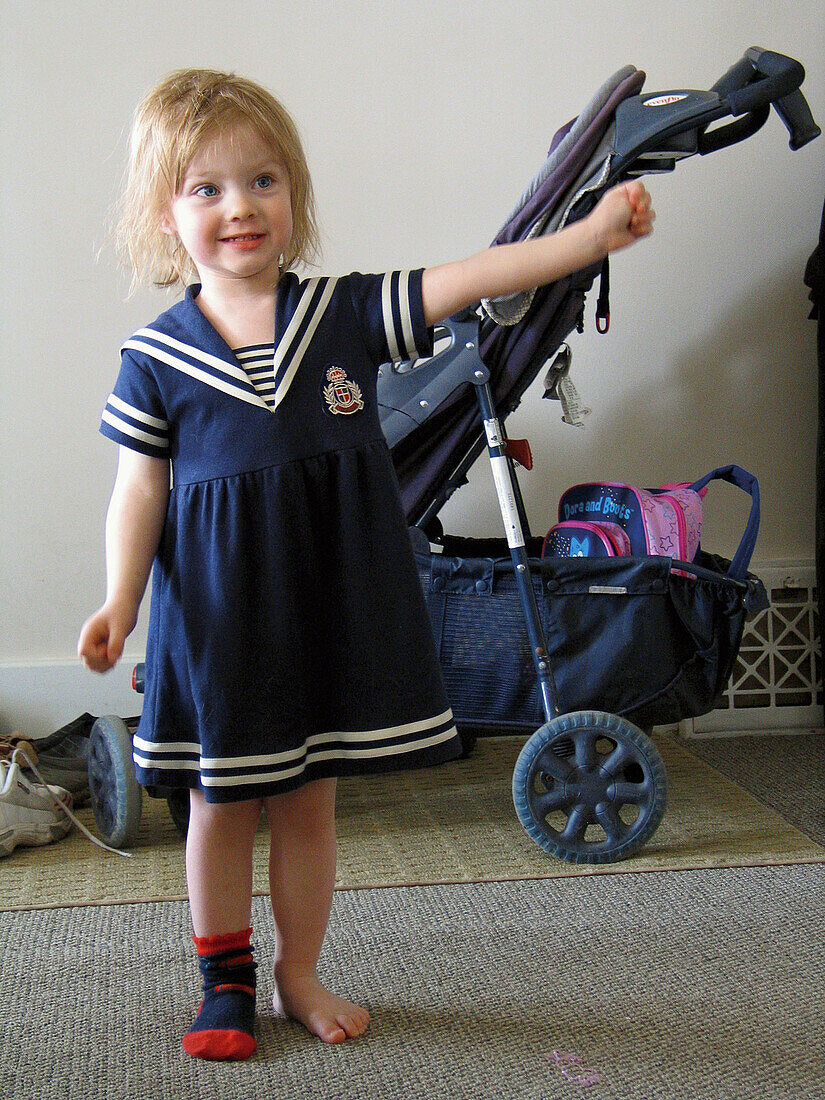 A little girl dresses in a sailor outfit to show off to her mother in Windsor. Ontario, Canada