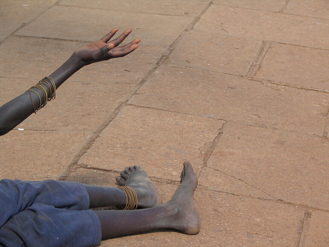 A child begs in downtown Kampala, Uganda.