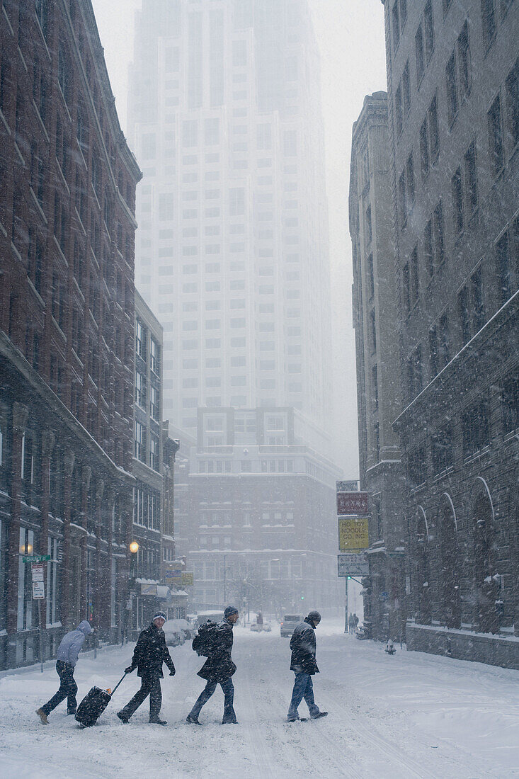 Snowstorm, Essex St., Boston, Massachusetts winter 4 men. USA.