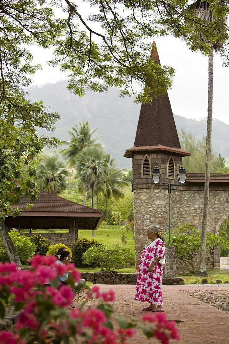 Woman talking in front of the church, Nuku Hiva, Marquesas Islands, Polynesia, Oceania