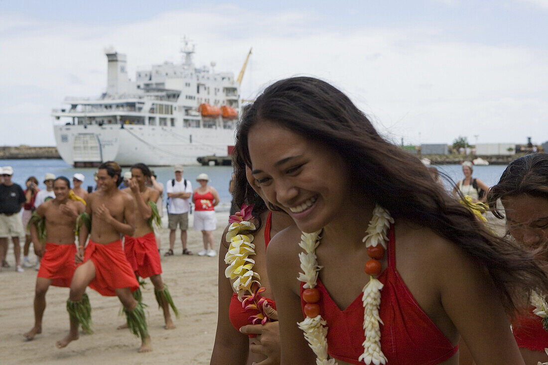 Laughing woman and men dancing welcome dance Aranui, Ua Pou, Marquesas, Polynesia, Oceania