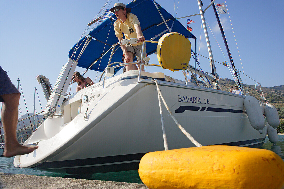 People fixing a boat on a mole, Ionian Islands, Greece