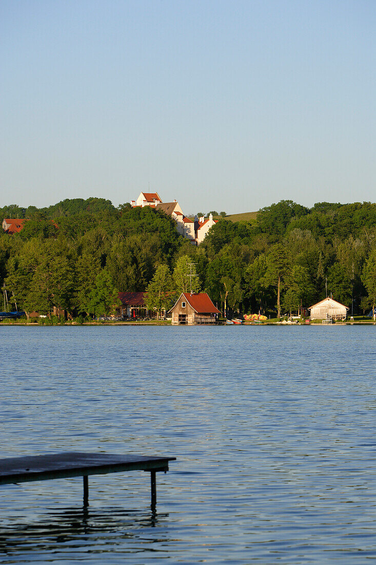 View over lake Pilsensee to castle Seefeld, Bavaria, Germany