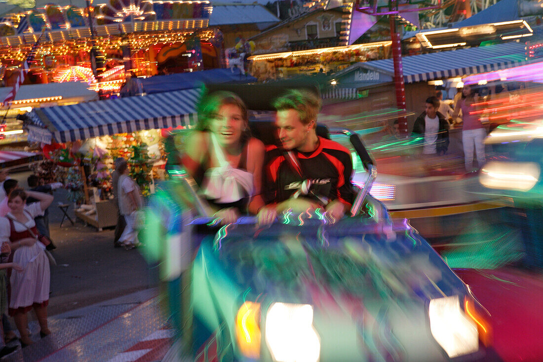 People at Carnival ride in the evening, Oktoberfest, Munich, Bavaria, Germany