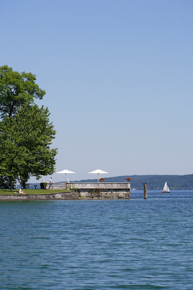 Private jetty with sunshades at lake Starnberg, Tutzing, Bavaria, Germany