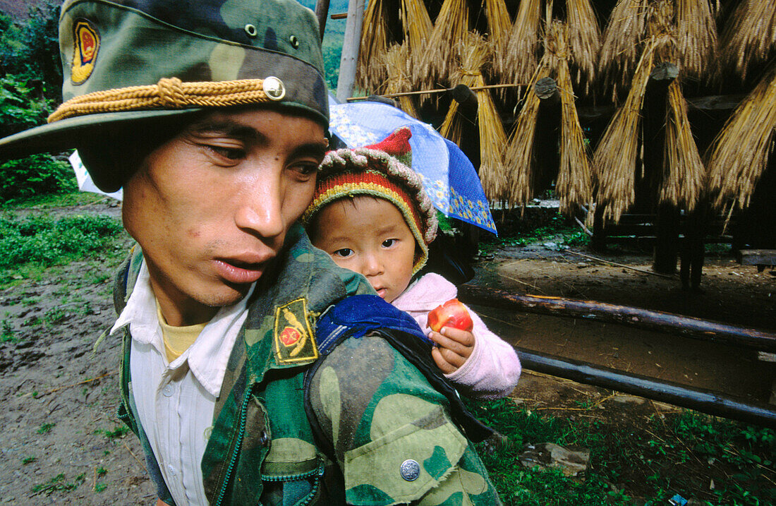 Lisu man with baby. Yunnan. China