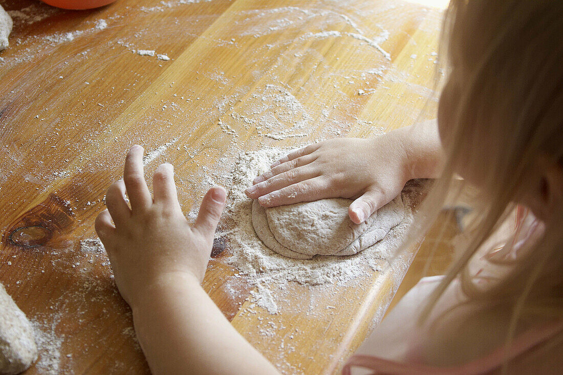 Hands of a child baking