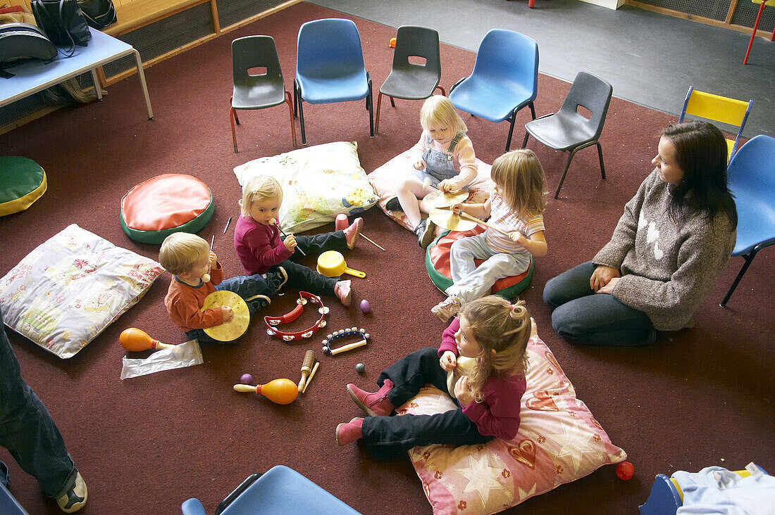 group of young children playing together in a music class