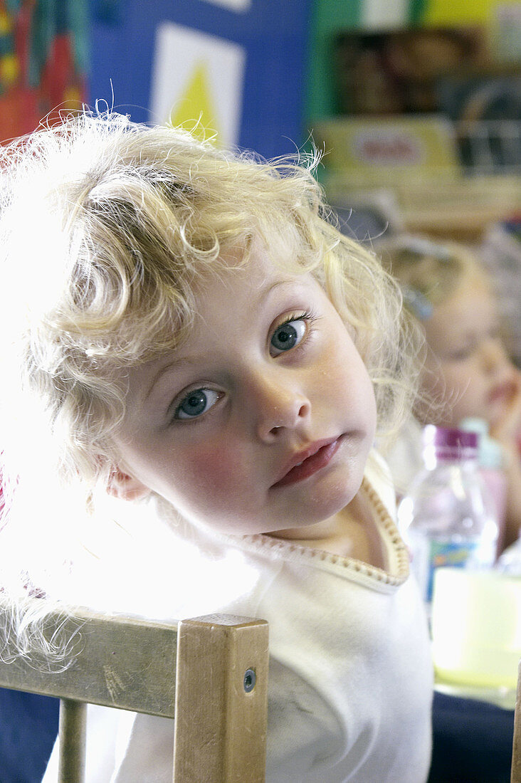 4 year old girl at nursery, smiling into camera