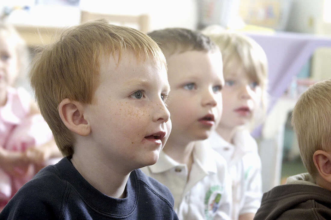 selective focus, headshot, 3 3 year old boys in a row at nursery