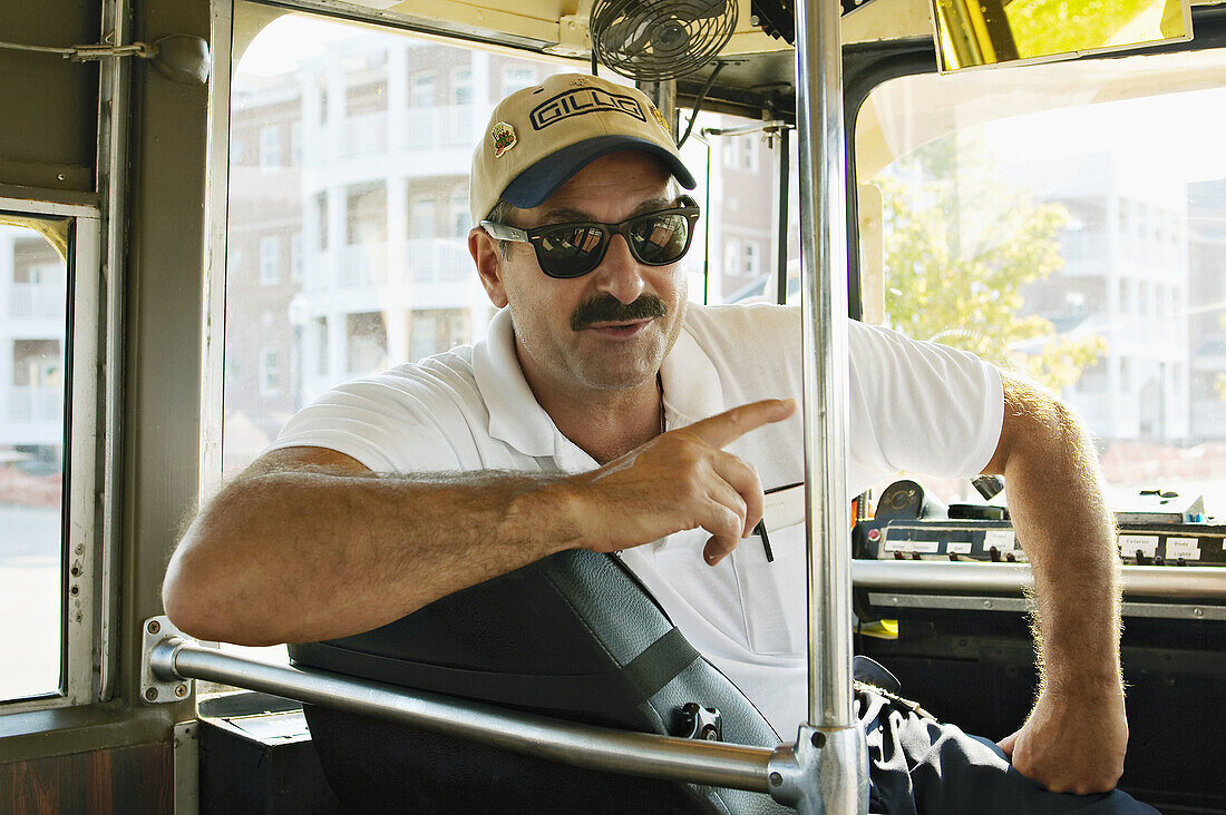 WISCONSIN. Kenosha. Restored streetcar, driver wearing baseball cap, turned around in seat, windshield