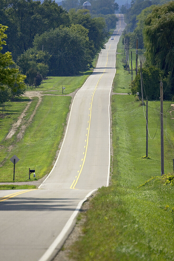 WISCONSIN. Kenosha County. Two land rural road through rolling hills, rural countryside in early fall